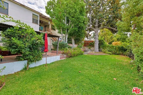 a front view of house with a garden