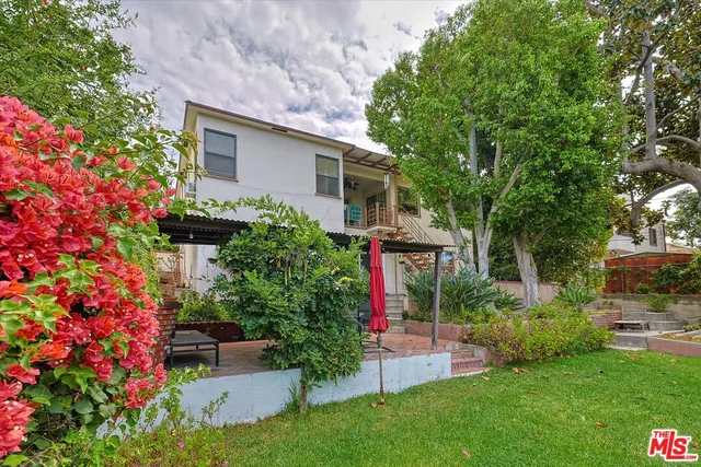 a view of a backyard with large trees
