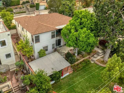 front view of a house with a tree
