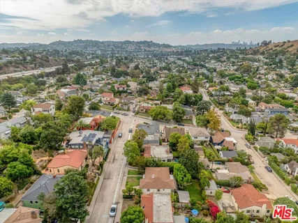an aerial view of residential houses with city view