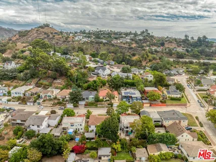 an aerial view of residential houses with outdoor space