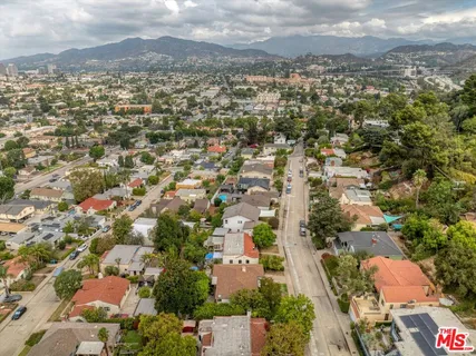 an aerial view of residential houses with outdoor space