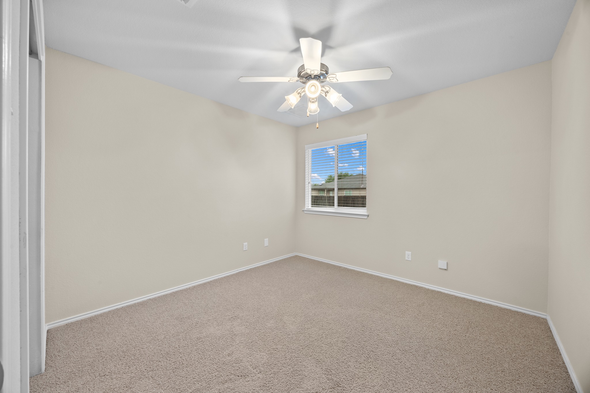 418 Nottingham Loop Kyle, TX 78640 - Photo 14 of 28 Neutral-toned room featuring light-colored carpeting, a window with horizontal blinds, and a ceiling fan with integrated lighting
