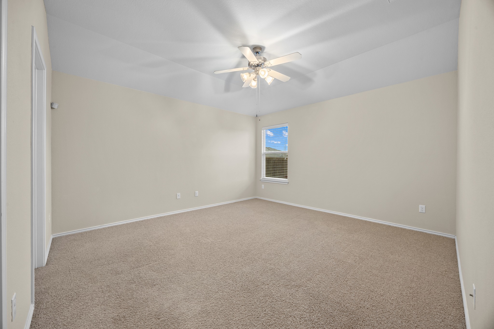 418 Nottingham Loop Kyle, TX 78640 - Photo 17 of 28 Spacious room featuring neutral carpeting, light-colored walls, a ceiling fan with light fixture, and a window with blinds