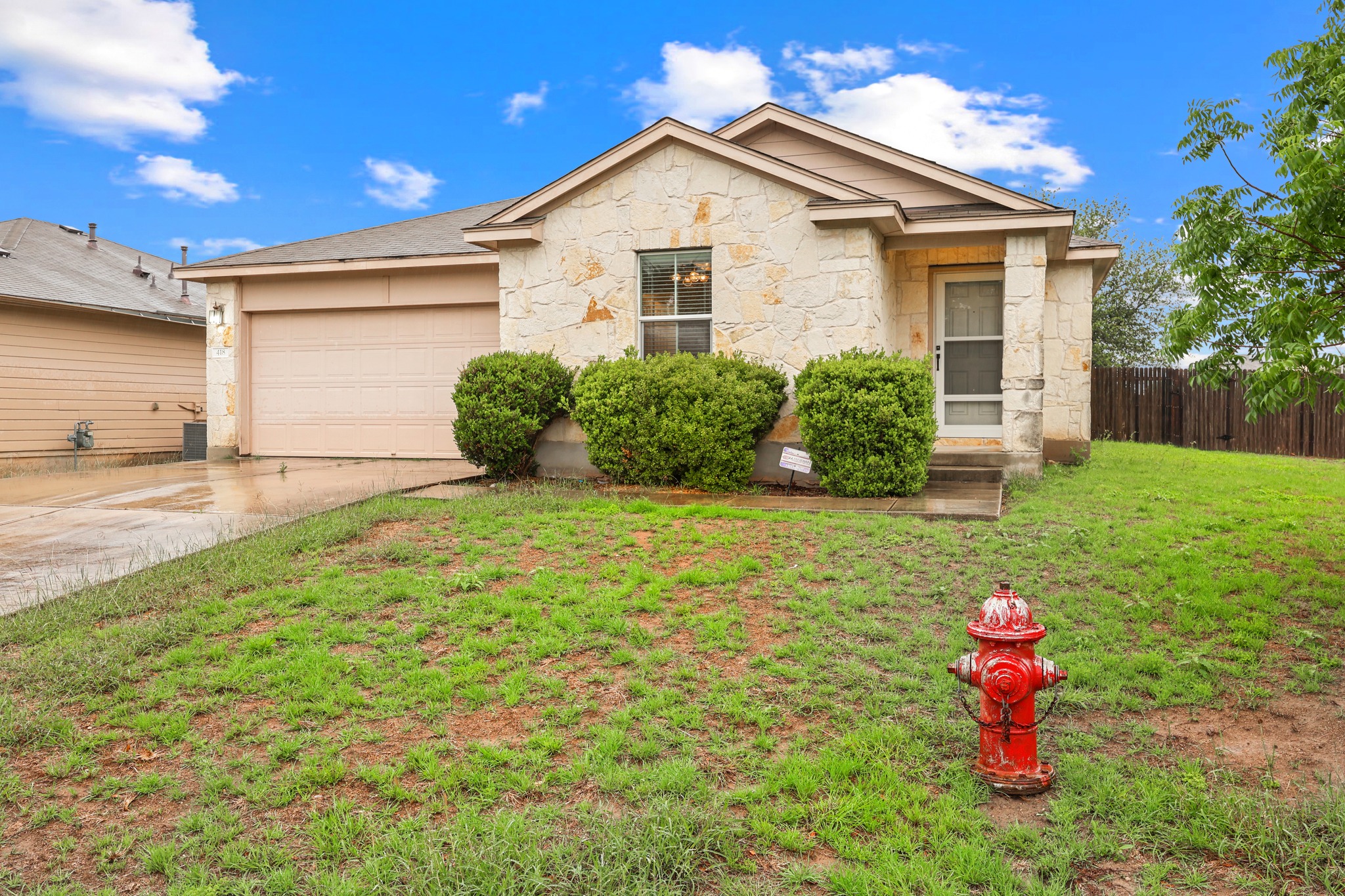 418 Nottingham Loop Kyle, TX 78640 - Photo 2 of 28 Single-story residence featuring a stone-clad exterior with a prominent front entrance