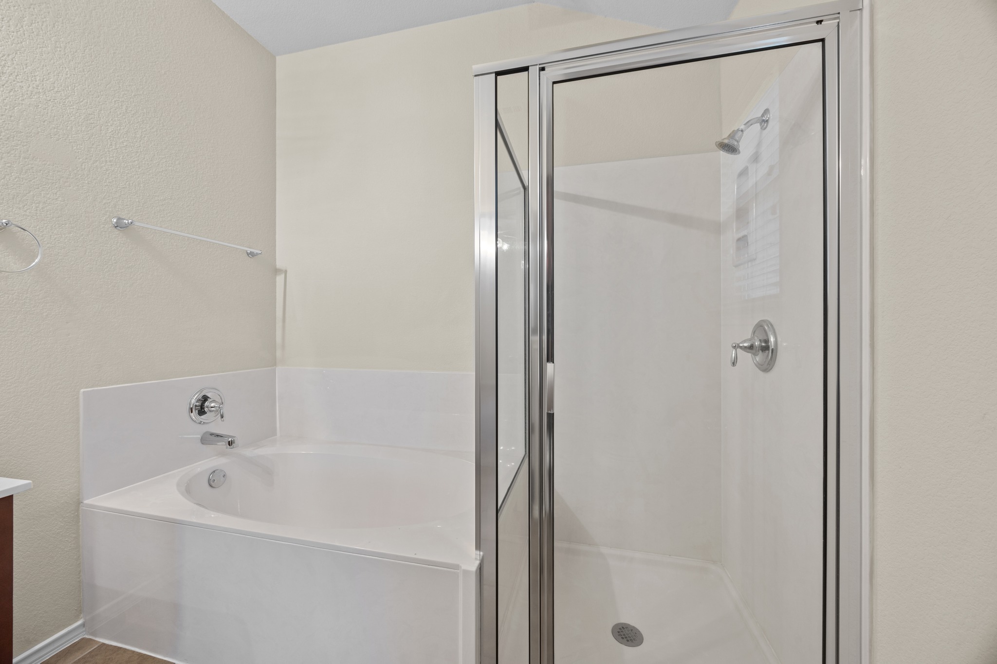 418 Nottingham Loop Kyle, TX 78640 - Photo 21 of 28 Bathroom featuring a built-in soaking tub with chrome fixtures and an adjacent glass-enclosed shower with a showerhead and control