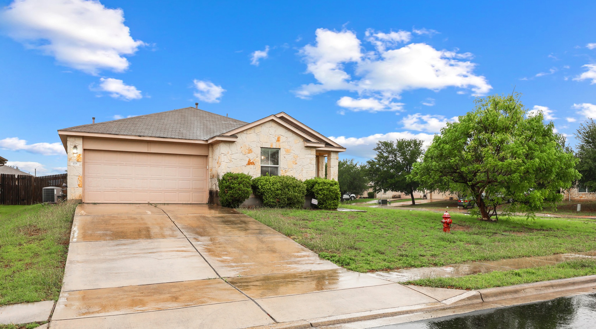 418 Nottingham Loop Kyle, TX 78640 - Photo 3 of 28 Stone facade with an attached two-car garage