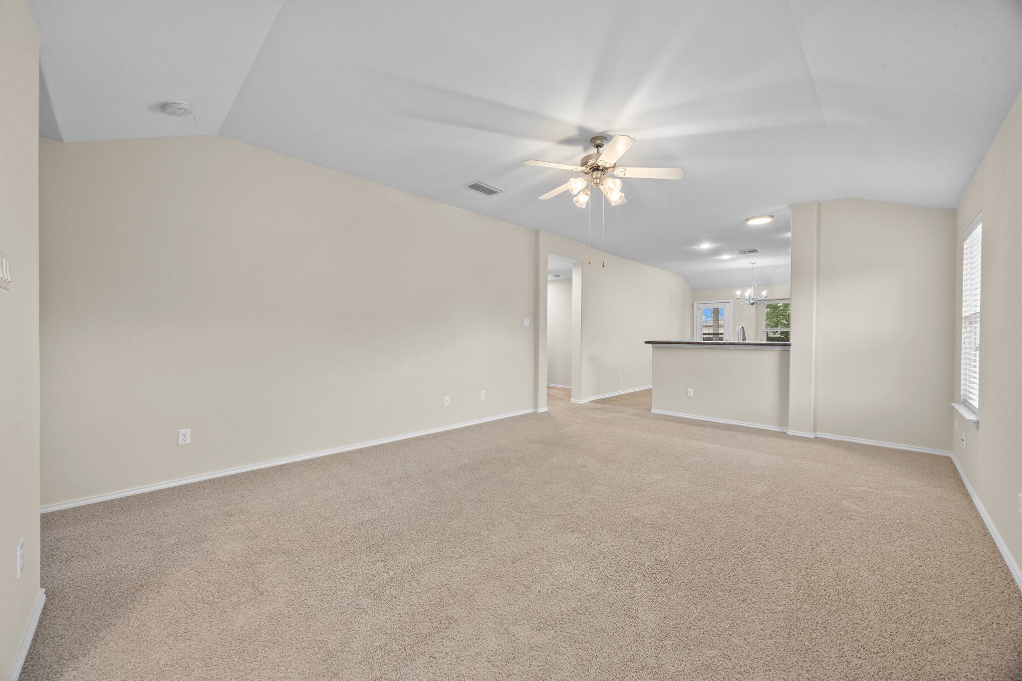 418 Nottingham Loop Kyle, TX 78640 - Photo 6 of 28 Spacious living area featuring neutral carpeting and light-toned walls