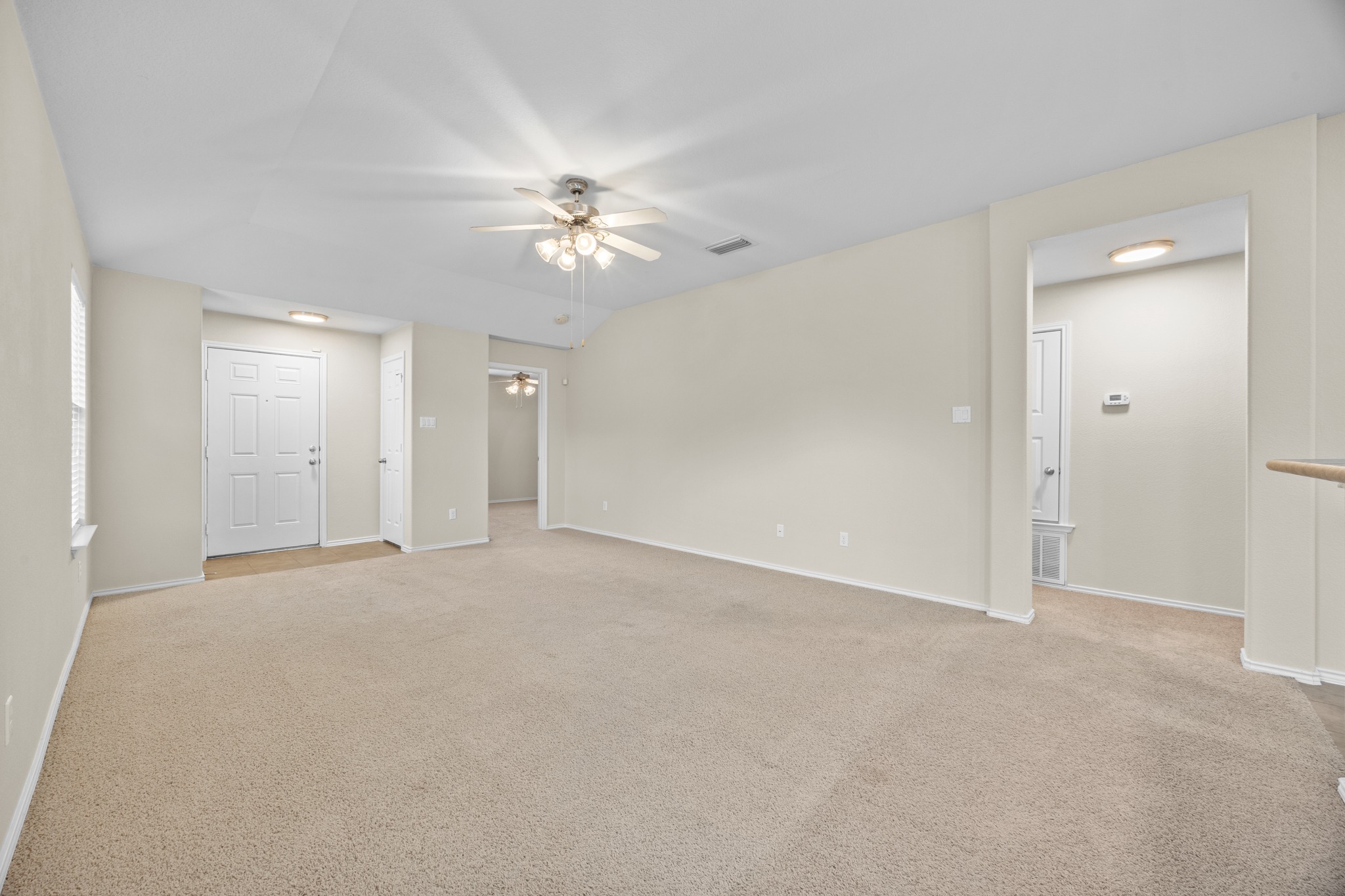 418 Nottingham Loop Kyle, TX 78640 - Photo 7 of 28 Spacious living area featuring neutral carpeting and light-toned walls