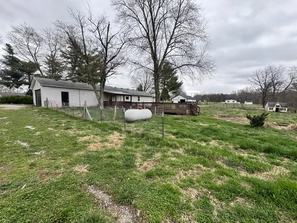 a view of a house with backyard and sitting area