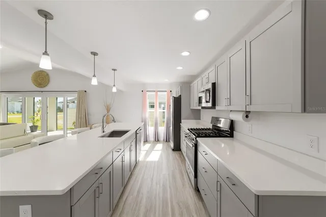 a large kitchen with a table and chairs