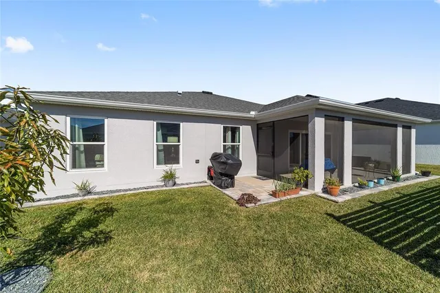 a view of house with backyard outdoor seating and hardwood