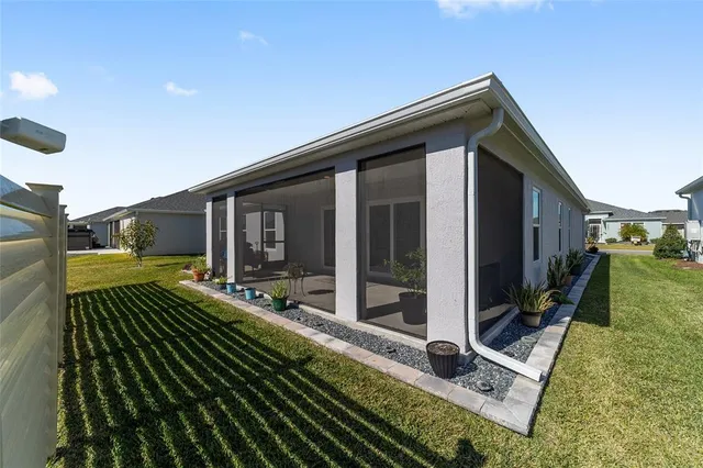 an aerial view of residential houses with yard