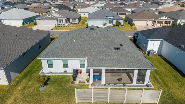 an aerial view of a house with a swimming pool