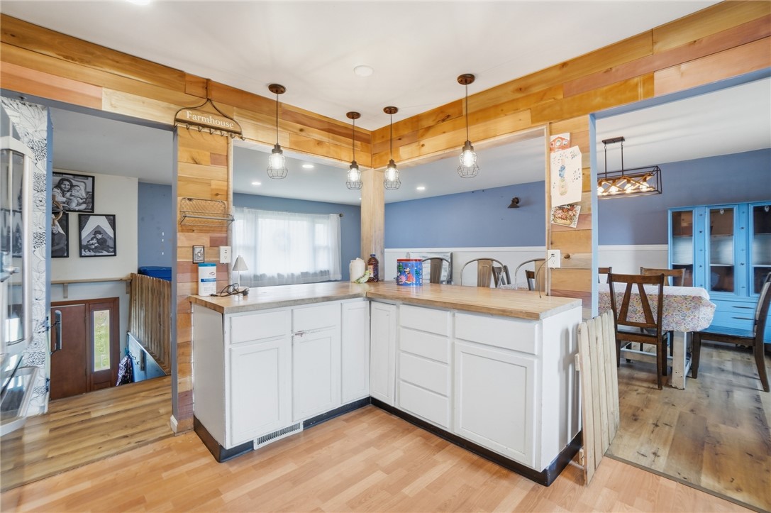 290 Ginghamsburg Road Tipp City, OH 45371 - Photo 19 of 49 This open concept kitchen and dining area features warm wood accents and contemporary lighting.