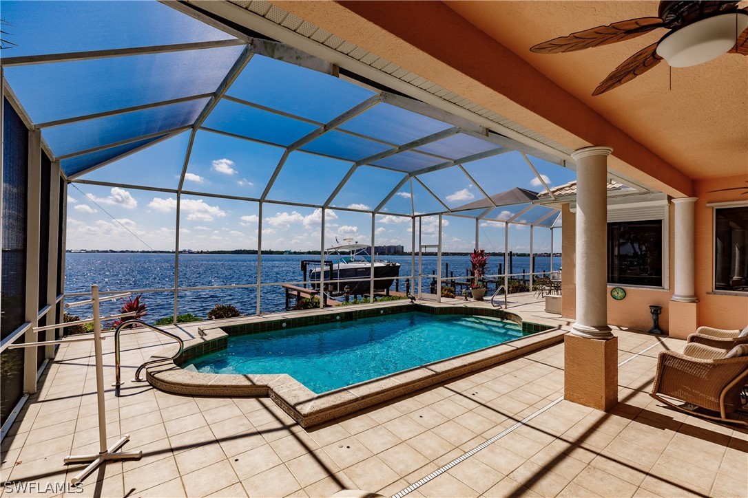 5727 Riverside Drive Cape Coral, FL 33904 - Photo 22 of 35 a patio with water view and pool table and chairs