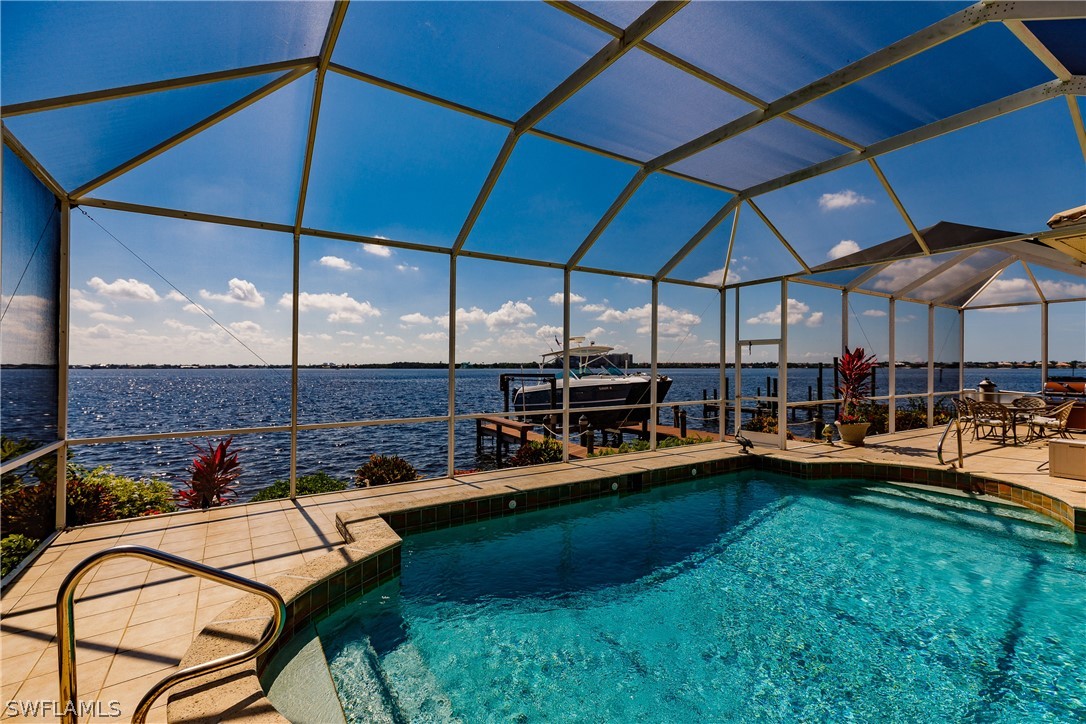 5727 Riverside Drive Cape Coral, FL 33904 - Photo 23 of 35 a view of a swimming pool with a patio