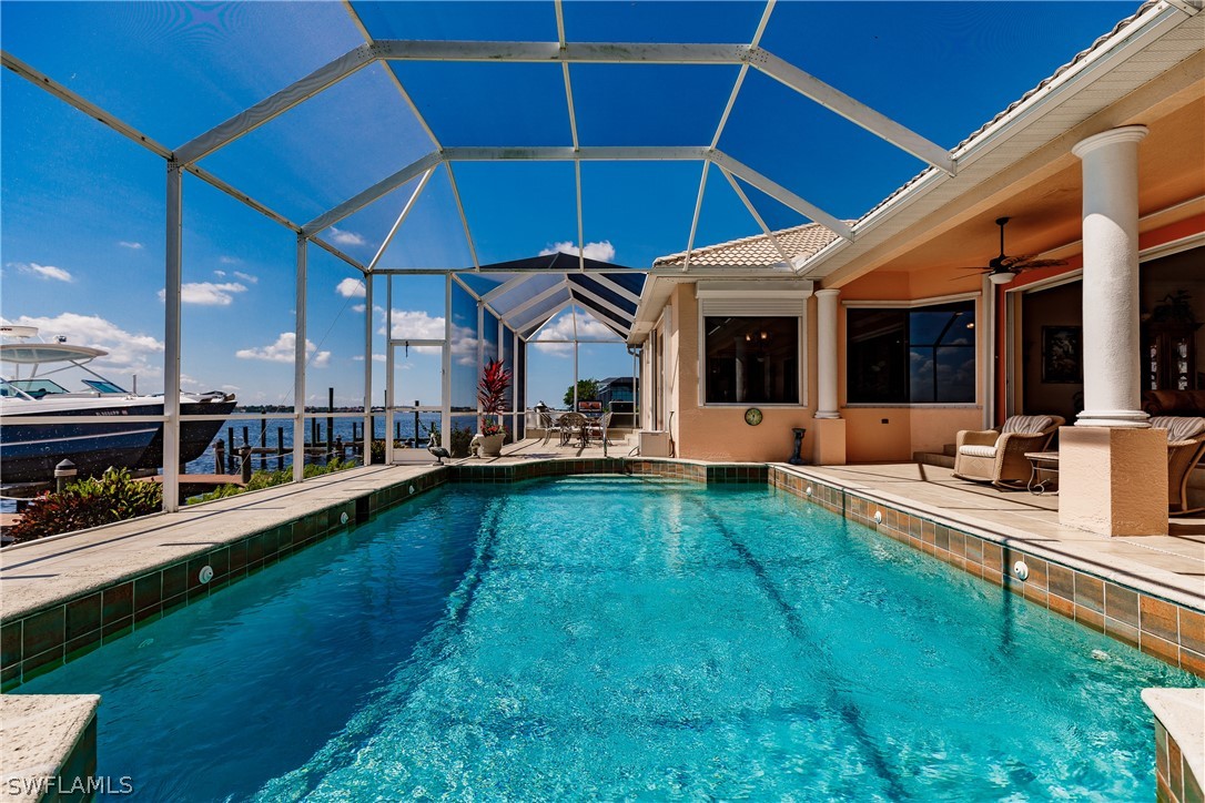5727 Riverside Drive Cape Coral, FL 33904 - Photo 24 of 35 a view of a patio with chairs and umbrellas