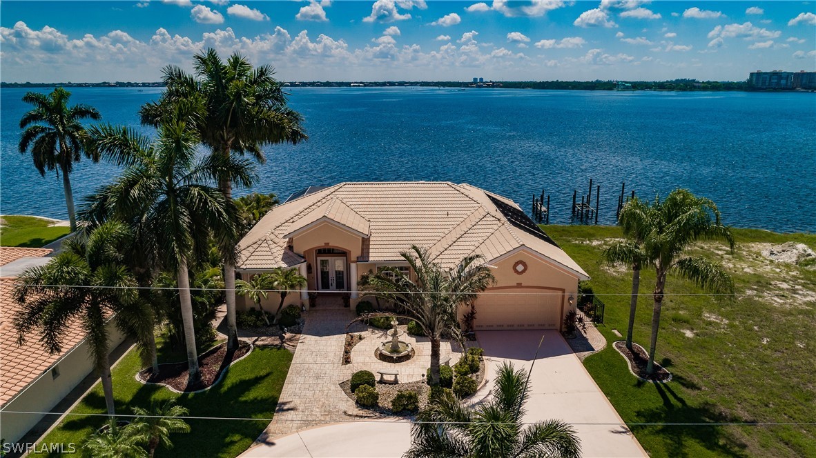 5727 Riverside Drive Cape Coral, FL 33904 - Photo 28 of 35 a view of a chairs and table in patio with lake view