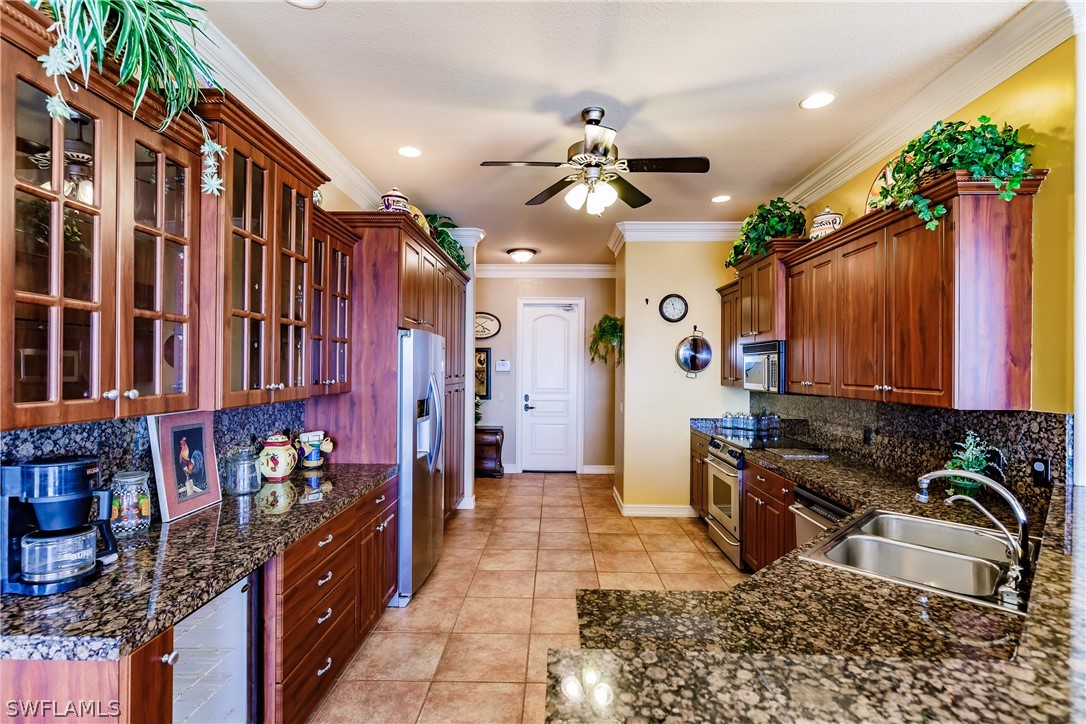 5727 Riverside Drive Cape Coral, FL 33904 - Photo 7 of 35 a kitchen with granite countertop a stove a sink and a refrigerator