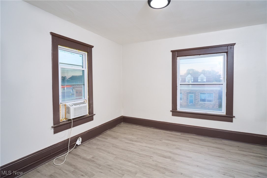 5432 State Road Parma, OH 44134 - Photo 36 of 47 Empty room with light wood finished floors and cooling unit