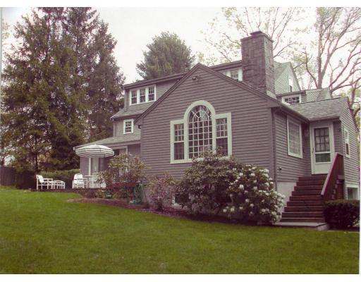 88 Hampshire Road Wellesley, MA 02481 - Photo 2 of 28 a front view of a house with a garden