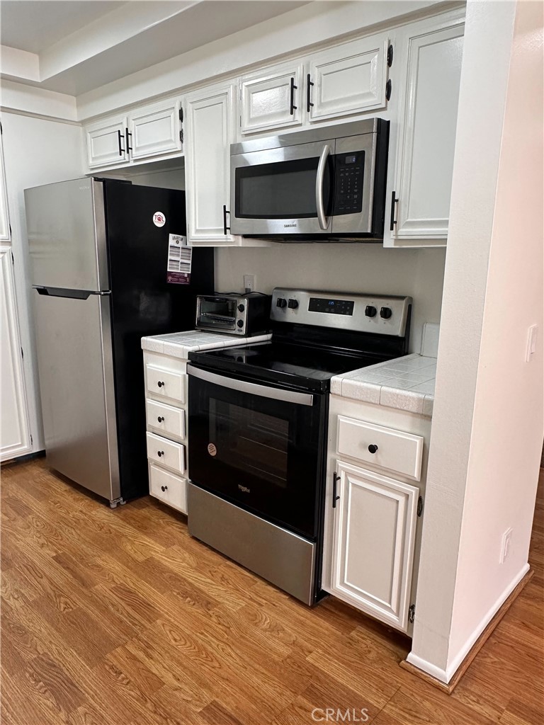 957 South Landmark Lane Anaheim, CA 92805 - Photo 14 of 24 a kitchen with stainless steel appliances a stove microwave and refrigerator