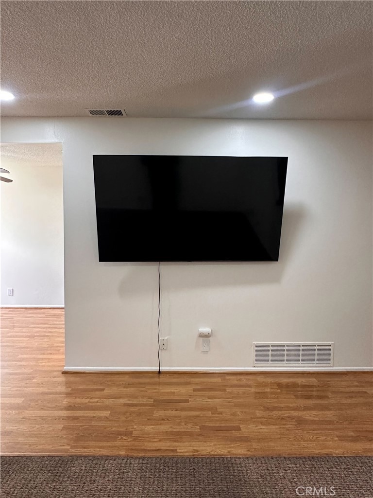 957 South Landmark Lane Anaheim, CA 92805 - Photo 8 of 24 a view of an empty room with wooden floor