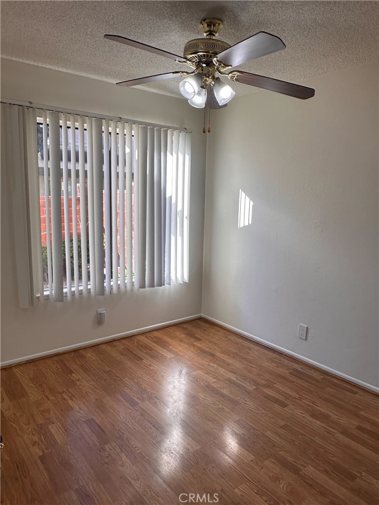 957 South Landmark Lane Anaheim, CA 92805 - Photo 10 of 24 a view of an empty room with wooden floor and fan