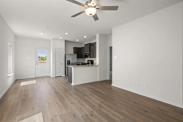 a view of kitchen with refrigerator microwave and stove