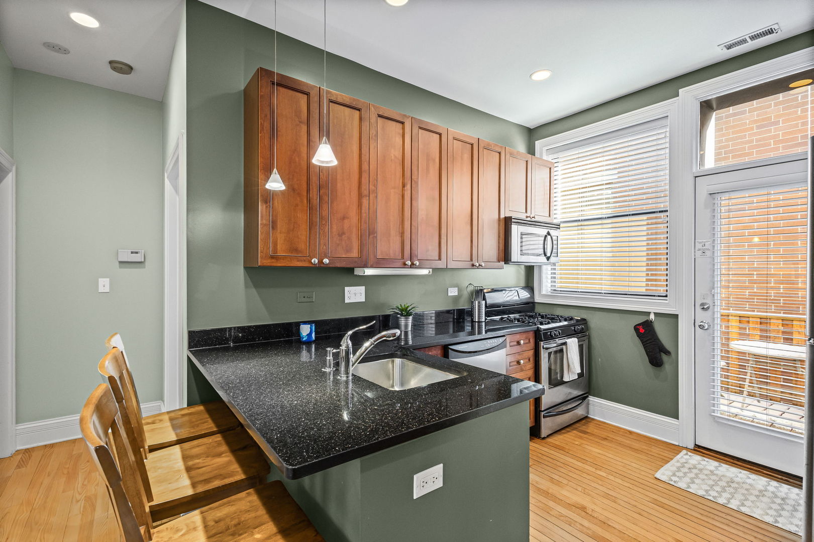667 West Barry Avenue, Unit 3N Chicago, IL 60657 - Photo 3 of 22 a kitchen with a sink a counter top space and living room area
