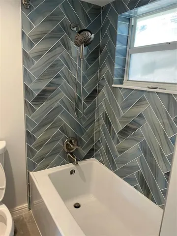 a bathroom with a toilet and a bathtub
