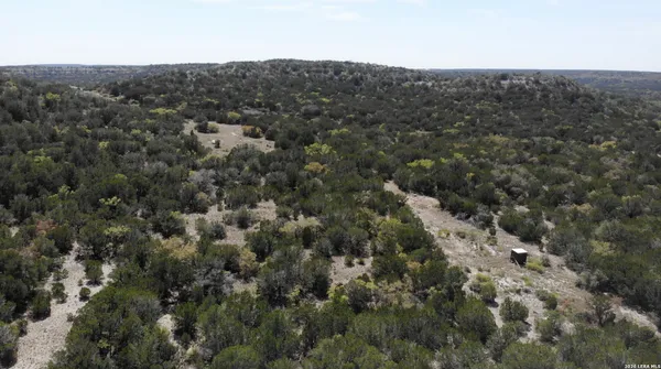 an aerial view of house with yard and mountain view