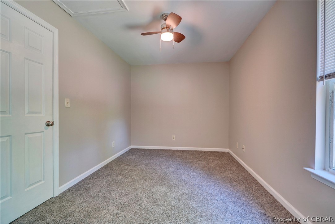 8269 Ark Road Gloucester, VA 23061 - Photo 15 of 33 Carpeted empty room featuring a healthy amount of sunlight and ceiling fan