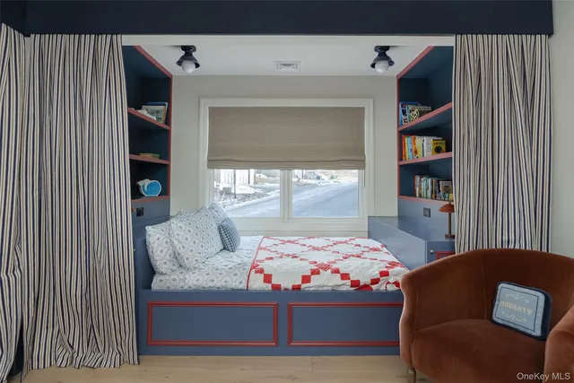 a bedroom with a bed and a bookshelf