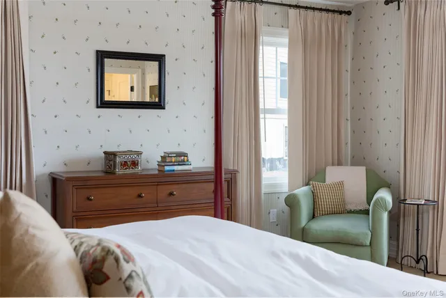 a bedroom with a bed and a television