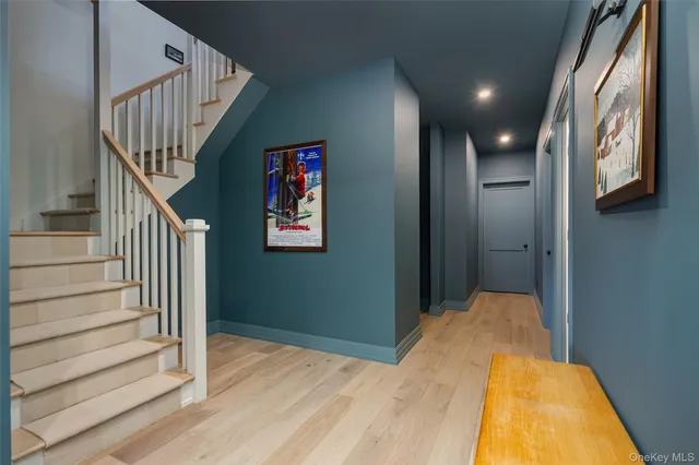 a view of a hallway with wooden floor and entryway