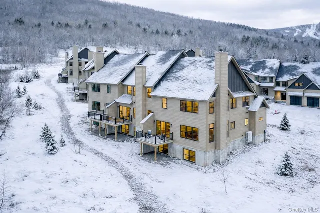 an aerial view of a house with a yard and sitting area