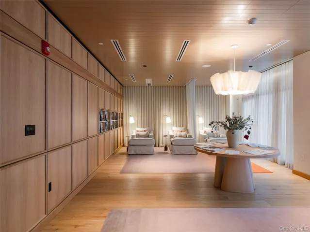 a lobby with furniture and a chandelier