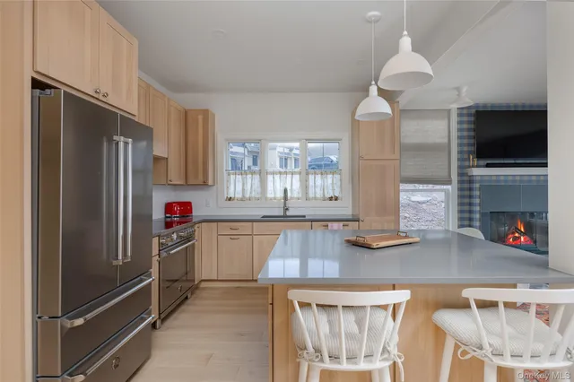 a kitchen with stainless steel appliances granite countertop a refrigerator and a sink