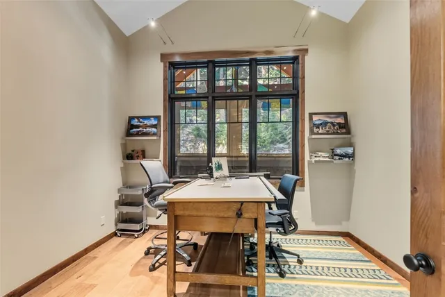 a view of a dining room with a table and chairs