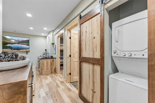 a view of washer and dryer with bathroom view
