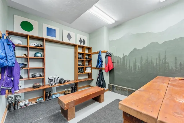 a living room with furniture and a book shelf