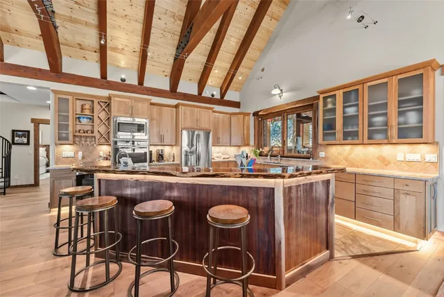 a dining table with chairs and wooden floor