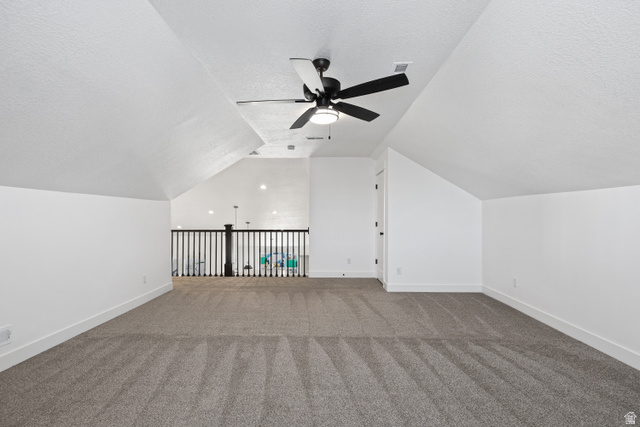 1139 South 4475 West West Point, UT 84015 - Photo 22 of 33 Additional living space with lofted ceiling, a textured ceiling, carpet floors, and a ceiling fan