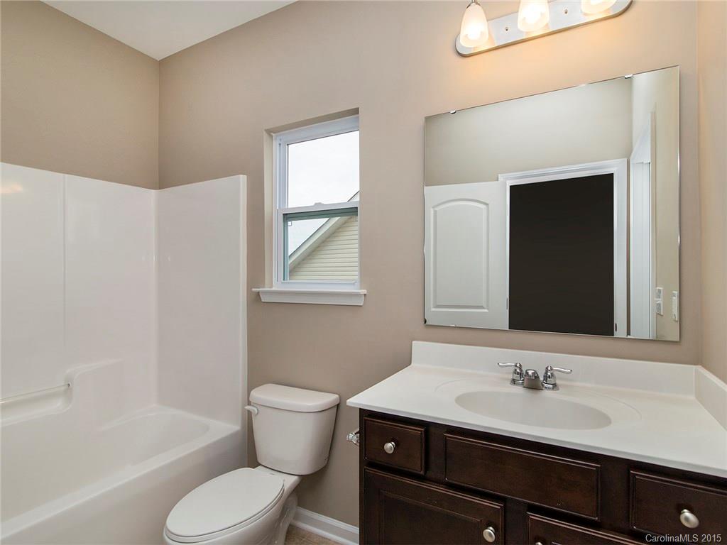 79235 Ridgehaven Road, Unit 4 Lancaster, SC 29720 - Photo 22 of 24 a bathroom with a sink a toilet and a bathtub
