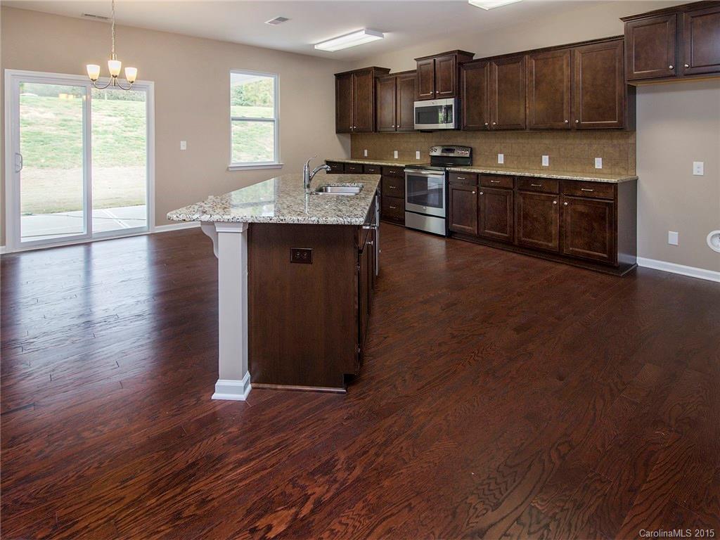 79235 Ridgehaven Road, Unit 4 Lancaster, SC 29720 - Photo 8 of 24 a kitchen with stainless steel appliances granite countertop a stove a sink and a microwave