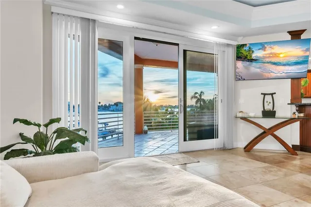 a bedroom with a large bed and a large window