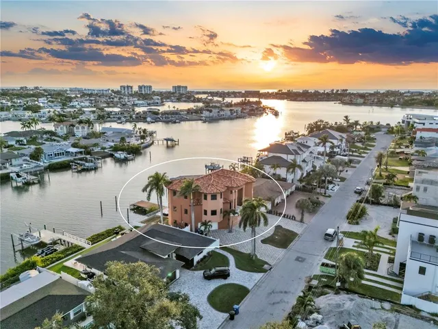 a living room with furniture kitchen view and a chandelier