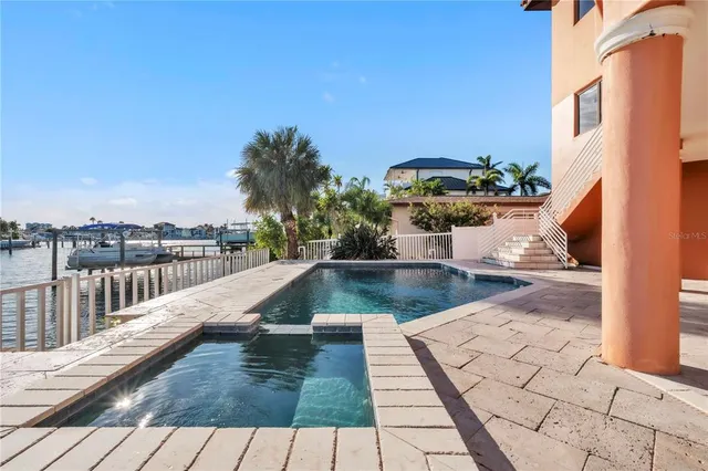 a kitchen with stainless steel appliances granite countertop a sink a stove and a refrigerator